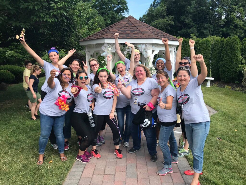 A victorious team celebrating after completing challenges at the Corporate Survivor team building event, showcasing teamwork and success.