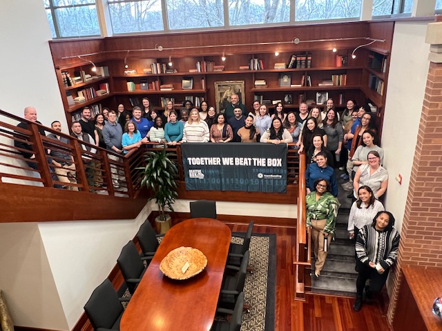 Group photo of participants celebrating their success in the Beat the Box team building event, highlighting teamwork and collaboration in solving the mind-bending challenges together.