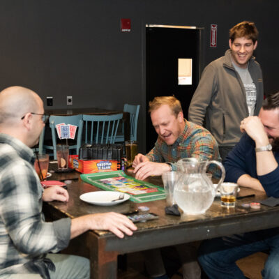 Team members share a moment of laughter while playing a board game during a lively team building networking event.