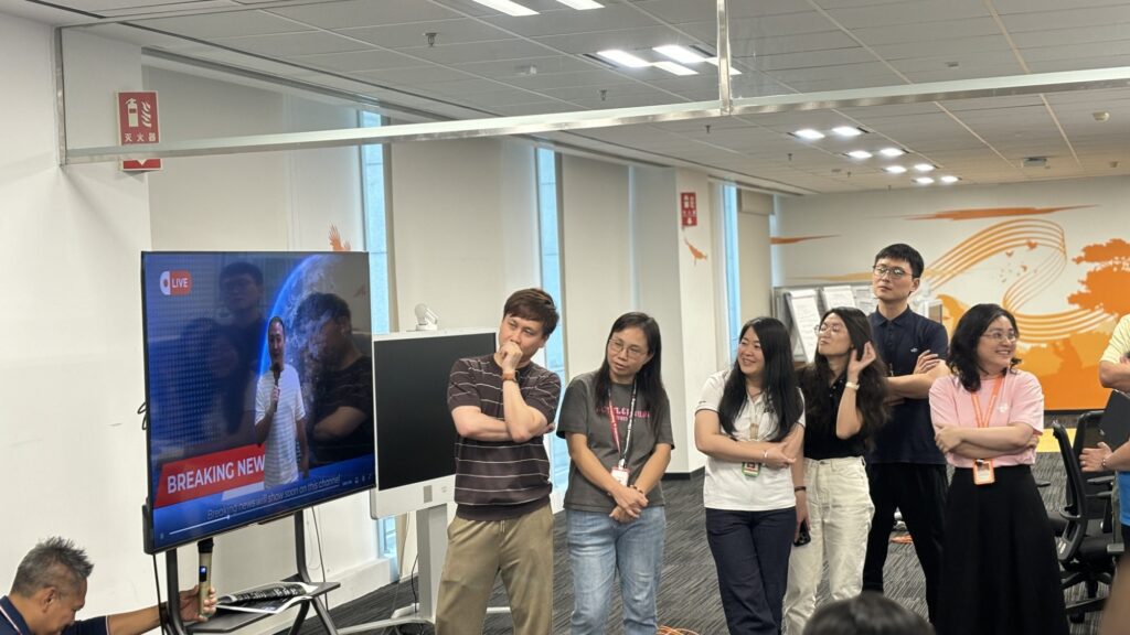 Participants gather around, watching the team building AI 