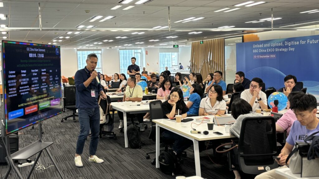 A team building event where participants engage in a high-energy activity, learning AI collaboration through creating news broadcasts and sharing insights with each other.