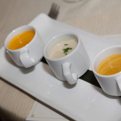 A selection of three different soups presented in small cups as part of the Dining in the Dark experience, highlighting the sensory nature of the event.