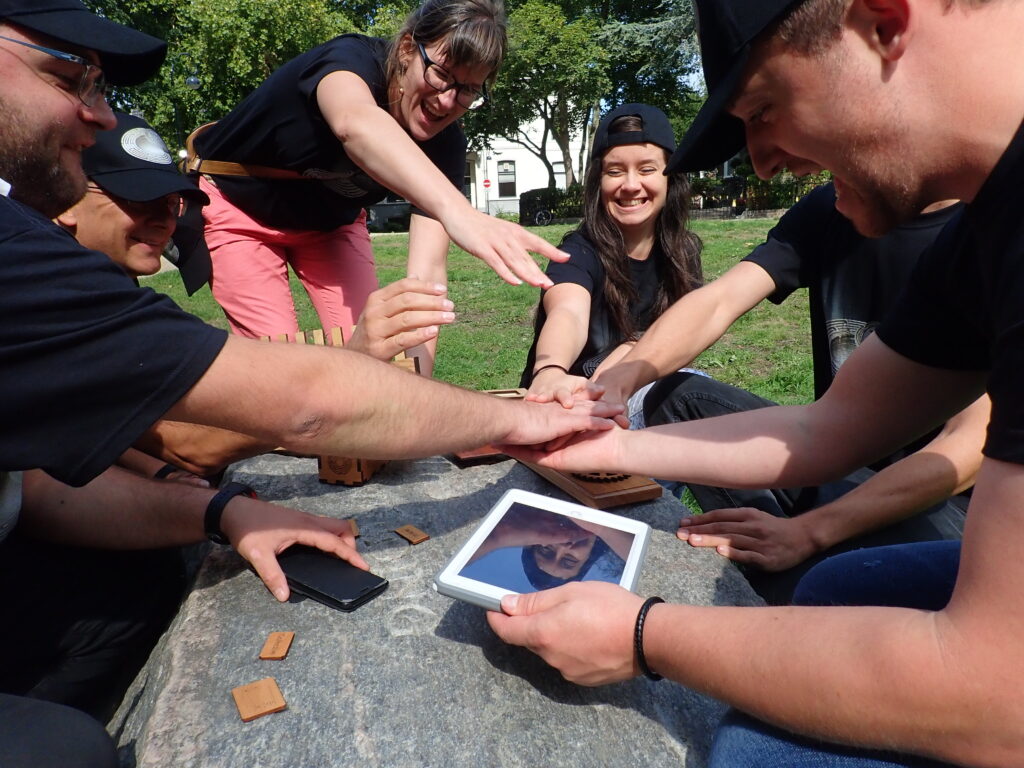 Team celebrates a successful checkpoint in the 'Escape The Maze' team building event, bonding over shared challenges and teamwork.