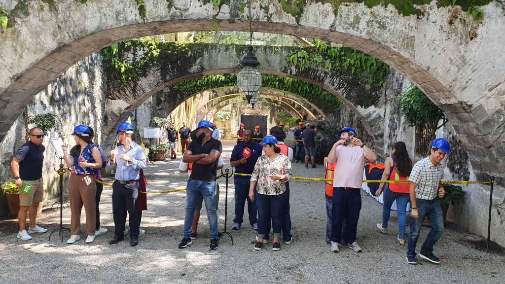 Outdoor team building activity with participants wearing hard hats and safety gear. Teams collaborate to complete a challenge, emphasizing communication, problem-solving, and teamwork in a dynamic setting.