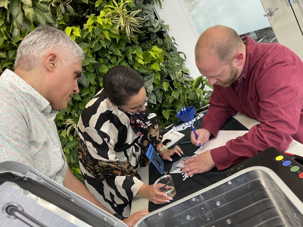 Participants collaborate closely during a Beat the Box team building challenge, brainstorming and working together to solve intricate puzzles and decode the next steps in this immersive experience.