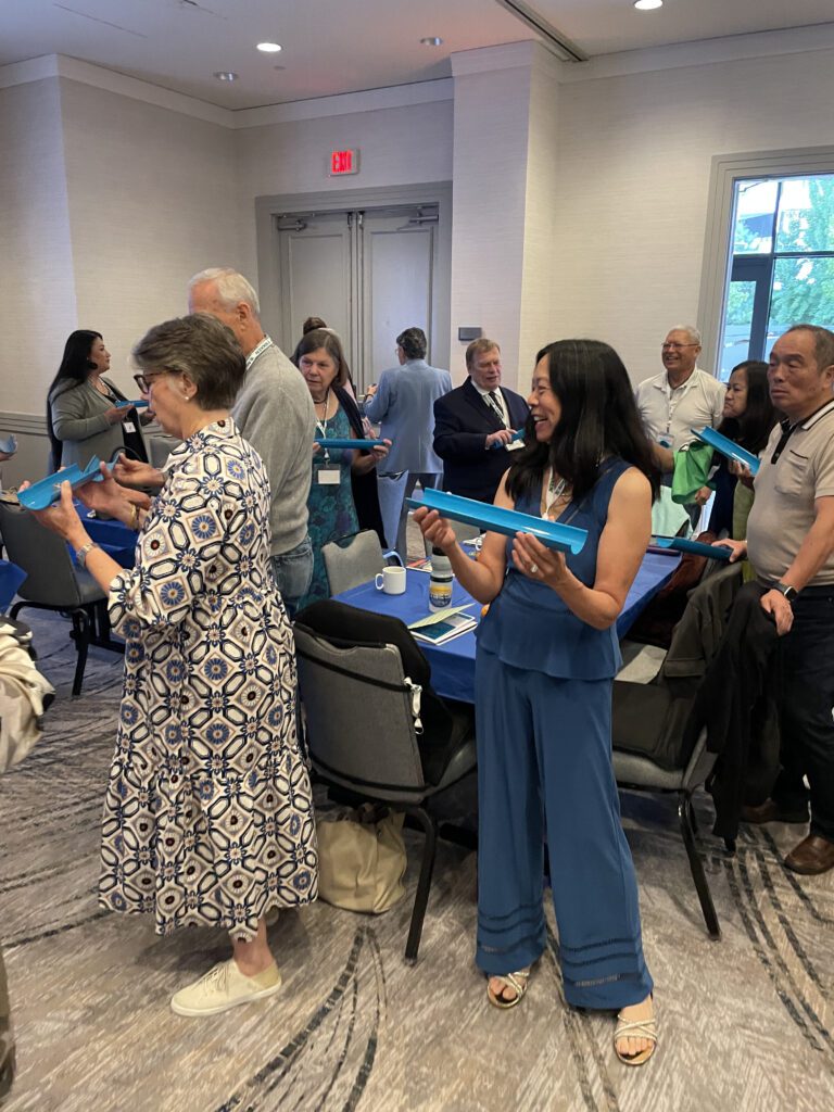 Participants working together to complete a challenge the 'Clean Water Connection' team building event.