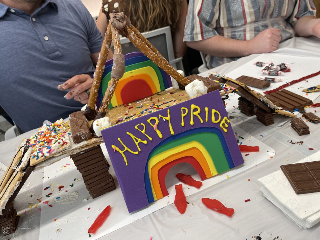 A colorful chocolate bridge constructed by a team during The Chocolate Challenge team building event. The bridge features a rainbow and a 