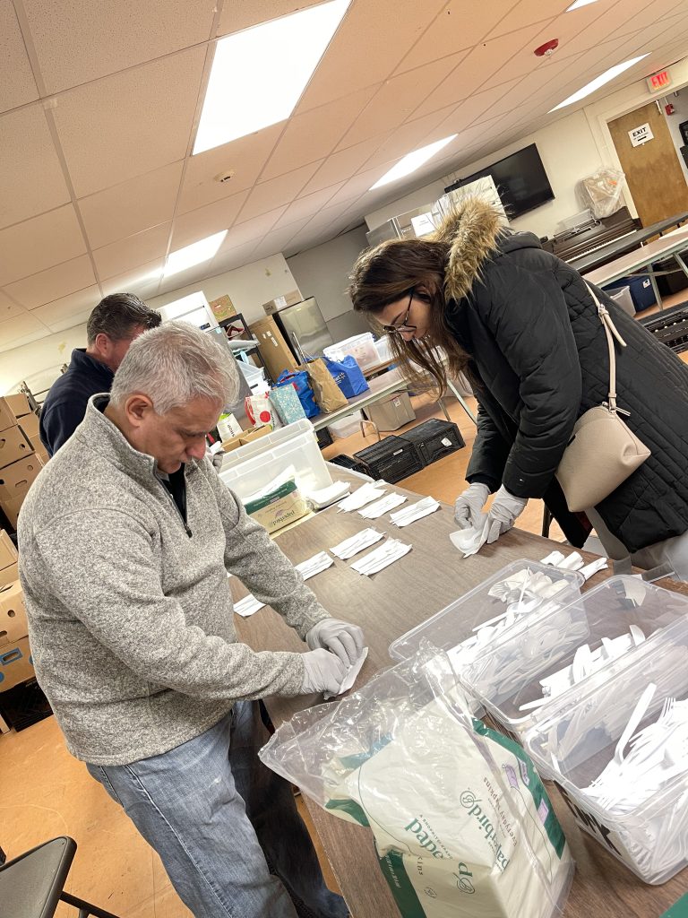 Team members working together to organize and prepare items for disaster relief care kits during the Team Disaster Relief event. The activity fosters collaboration and teamwork while making a real-world impact.