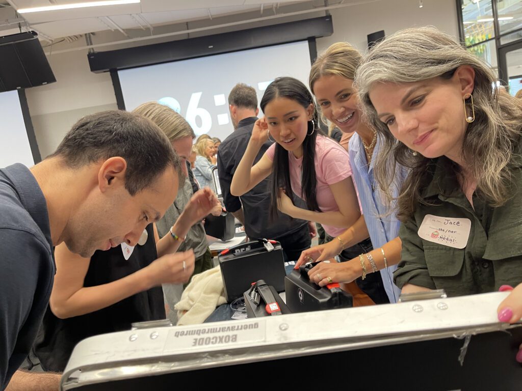 Focused participants work together to crack codes and solve puzzles during the Beat The Box team building event, racing against the clock to unlock the next challenge.