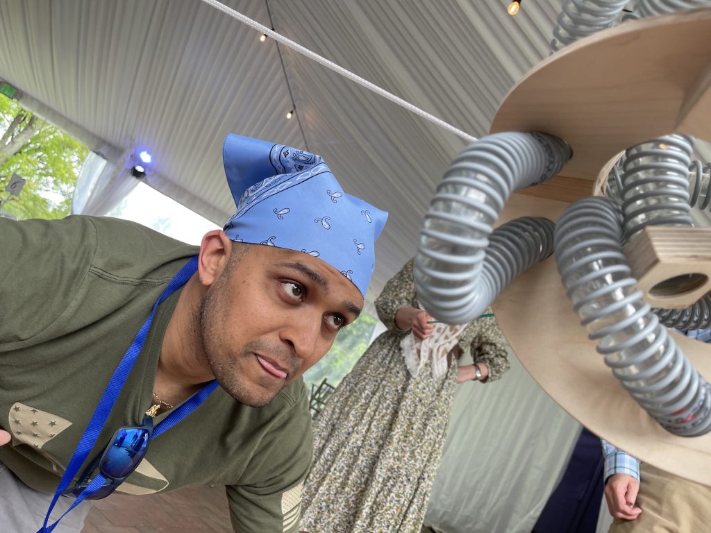 A participant engaged in the Integrity team building event, carefully navigating a physical challenge involving ropes and a large mechanical structure.