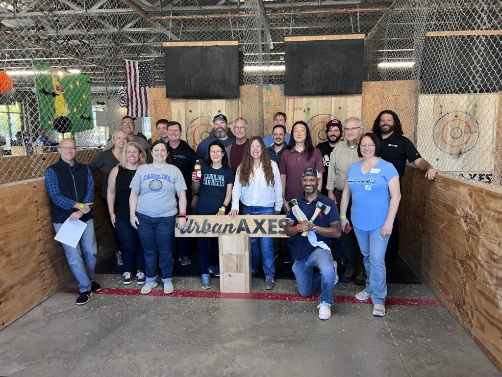 Team bonding at Urban Axes, where colleagues enjoy an exciting axe-throwing activity as part of their Mystery Bus team building adventure.