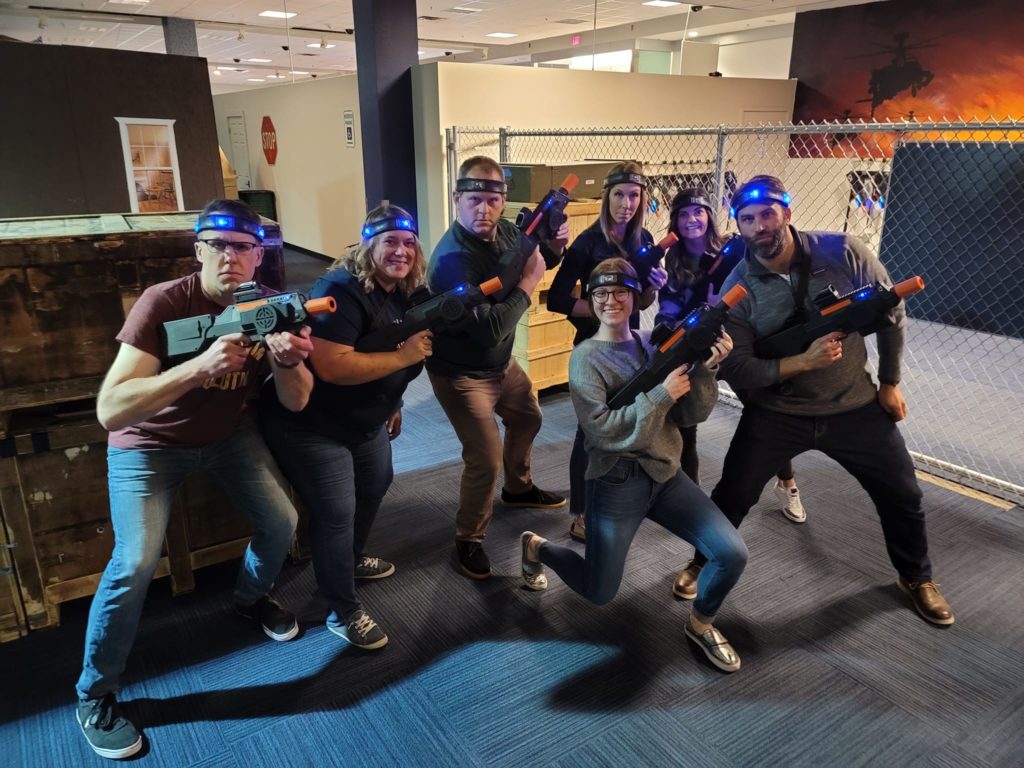 Team gearing up for a thrilling laser tag battle during a Mystery Bus team building event, fostering camaraderie through fun and active competition.