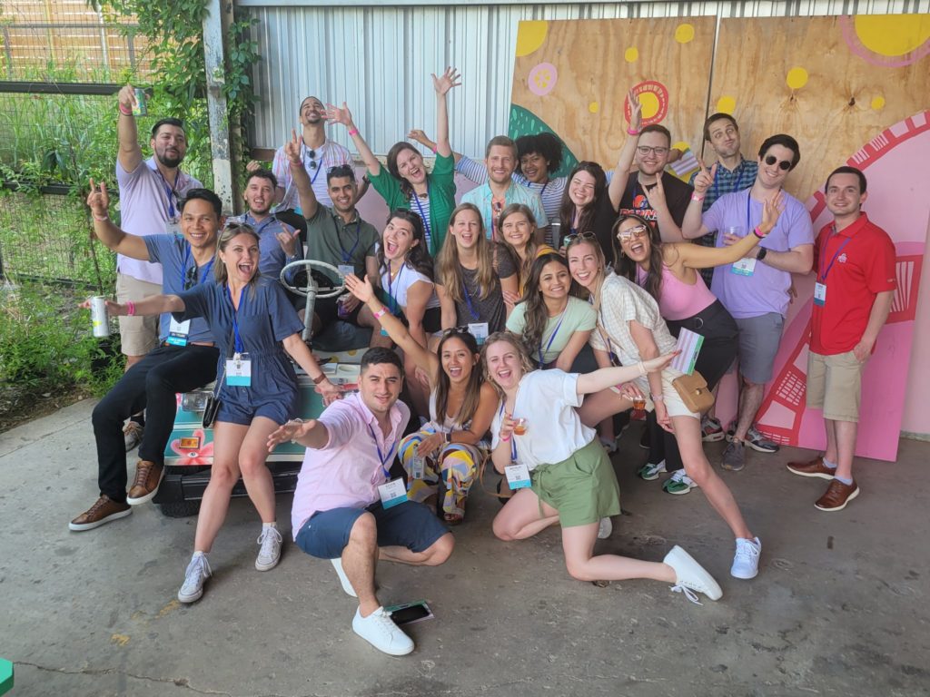 Group photo of a team full of energy and excitement during a Mystery Bus team building event, posing together for a fun and memorable moment.