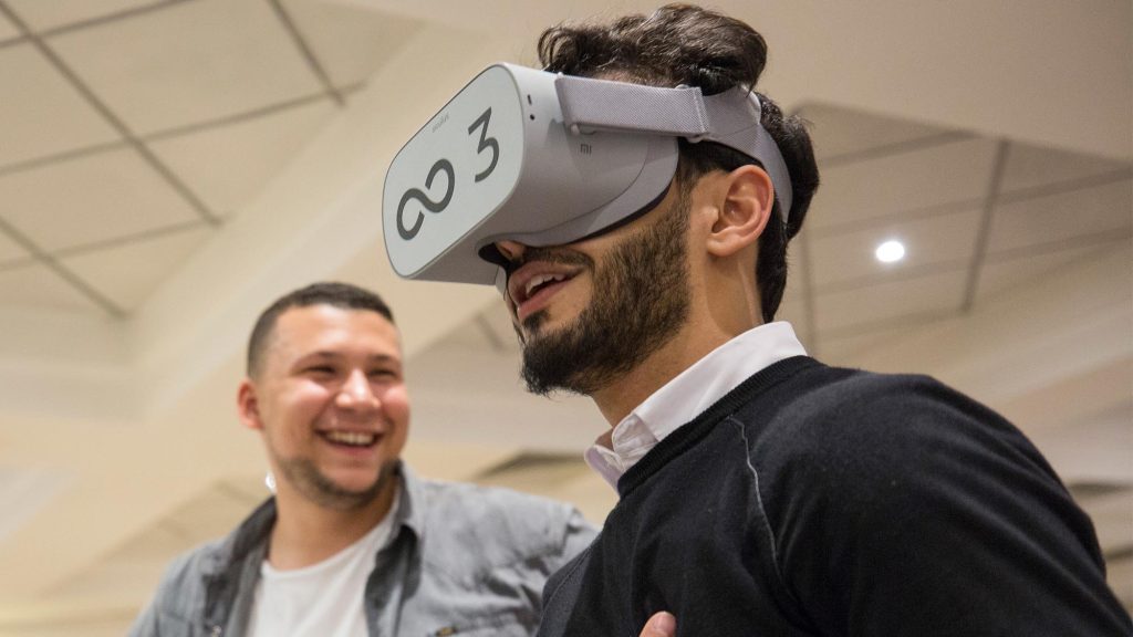 Participant wearing a VR headset during The Infinite Loop team building event, immersed in a virtual world challenge. The activity promotes communication, collaboration, and problem-solving as teams work together to solve challenges in the virtual realm.