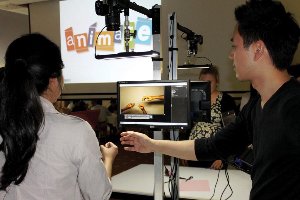 Team members filming a stop motion animation scene during a team building event focused on creativity and collaboration.